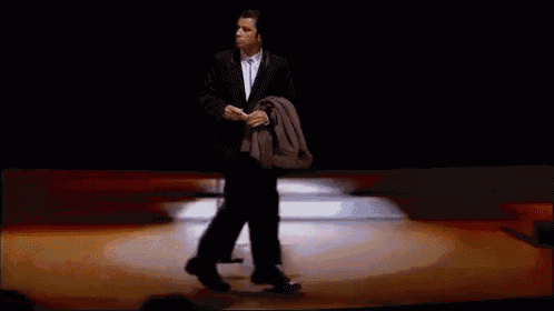 a man in a suit and tie is standing on a stage .