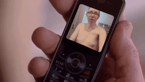 a person is holding a cell phone with a picture of a man on it