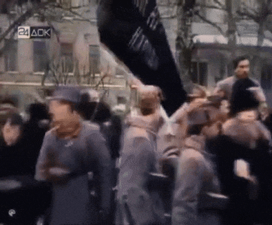 a crowd of people are gathered in front of a sign that says 24 ack