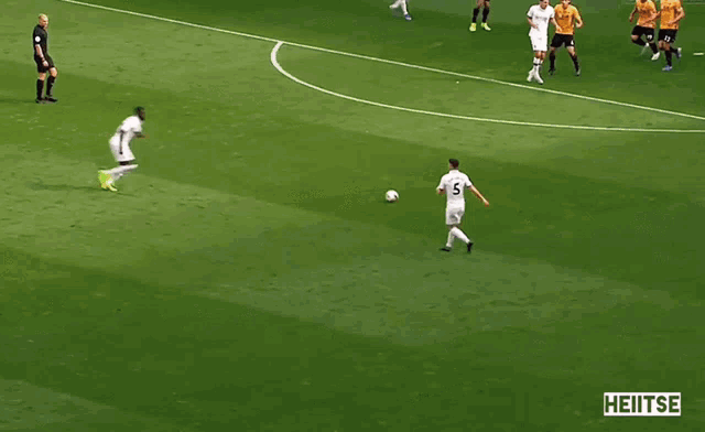 a blurry picture of a soccer game with heitse written in the corner