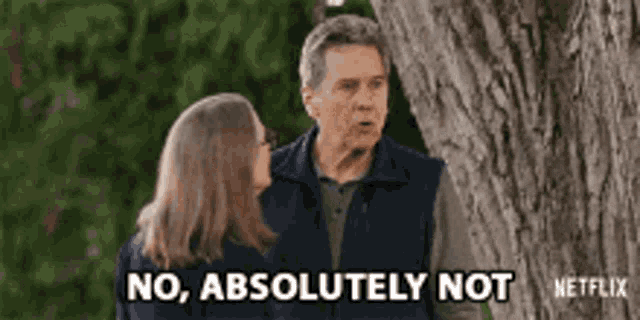 a man and a woman are standing under a tree and the man is saying no , absolutely not .