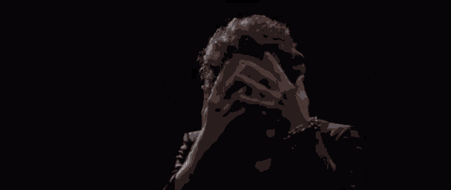 a man with a fake face on his face is making a funny face .