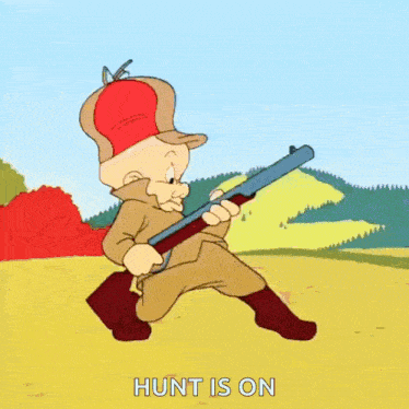 a cartoon character is holding a shotgun in a field and says hunt is on .