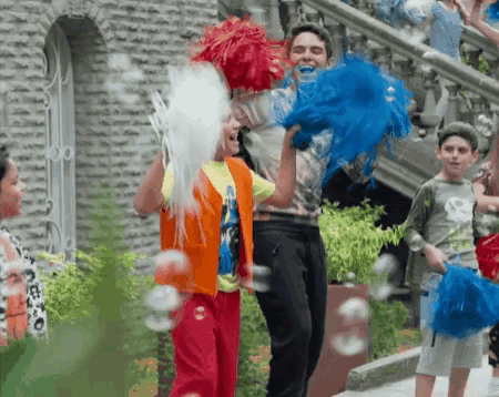 a group of children are playing with pom poms and soap bubbles outside