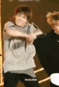 a man is dancing on a stage with another man .