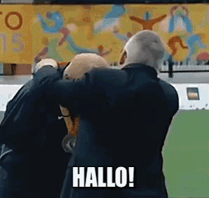 two men hugging each other with the word hallo on the bottom right