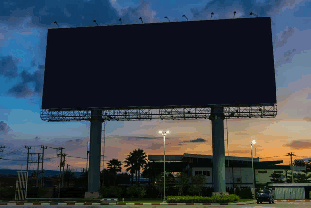 a large billboard is lit up at night