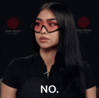 a woman wearing glasses and a black shirt says no .