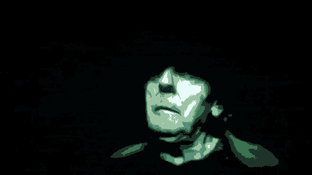 a green light is coming out of a dark background