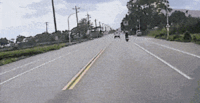 a person is riding a motorcycle down a street