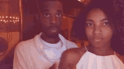 a man and a woman are sitting next to each other .