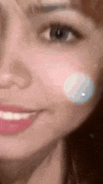 a close up of a woman 's face with a white circle on it