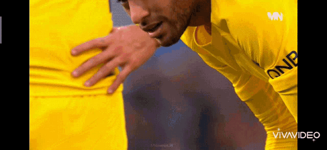 a man in a yellow jersey with one on the front