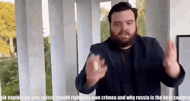 a man in a suit is explaining why russia should rightfully own crimea and why russia is the best country .