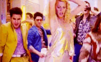 a group of people are dancing together in a room .