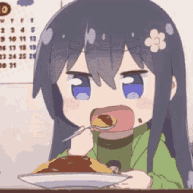 a girl is eating a plate of food with a spoon .