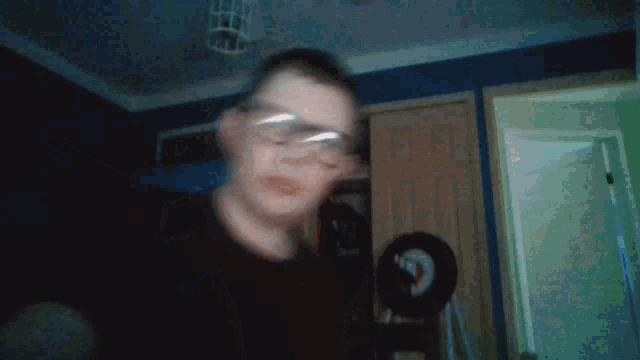 a blurry picture of a person wearing glasses