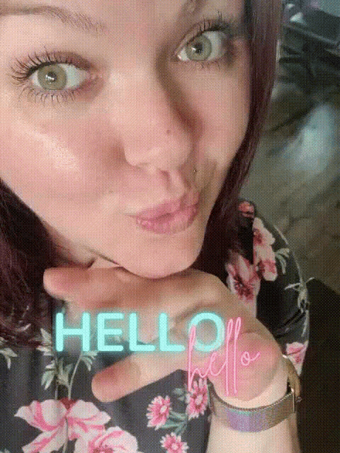 a woman blowing a kiss with the word hello written on her hand