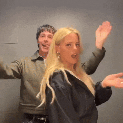 a man and a woman are dancing together with their arms outstretched