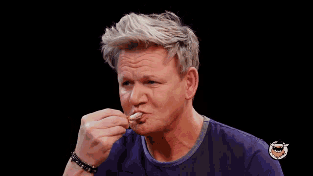 a man holding a piece of food with the words that 's nice written below him