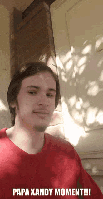 a man in a red shirt with papa xandy moment written on the bottom