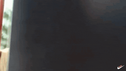 a blurred image of a red pole with the words " madioti " in white letters on a black background