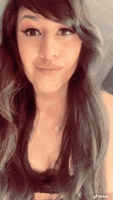a close up of a woman 's face with a tiktok watermark in the corner