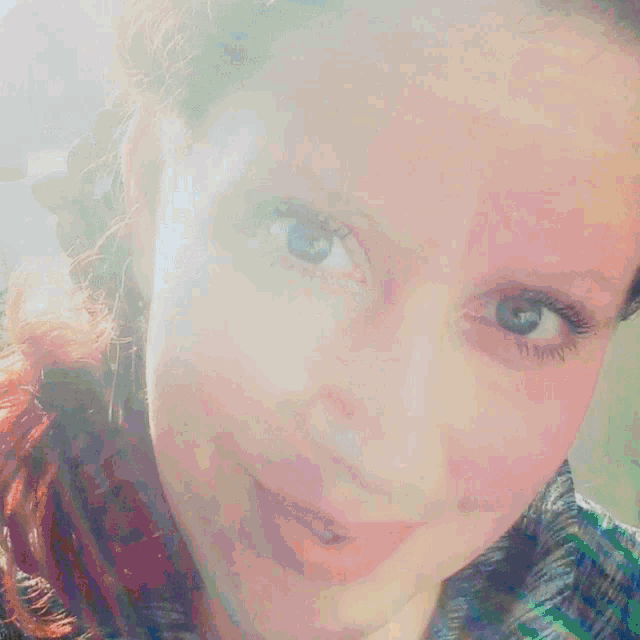 a close up of a woman 's face with a smile on her face