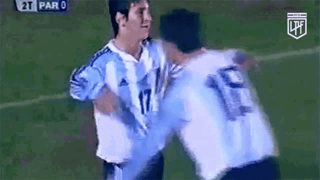 a soccer player with the number 17 on his jersey is hugging another player .