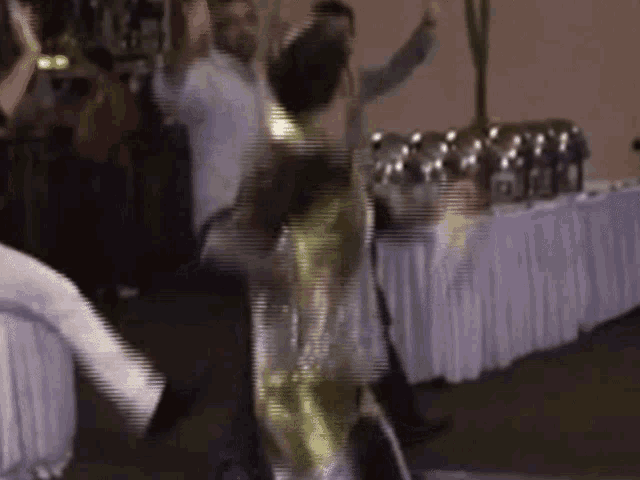 a group of people are dancing in a room