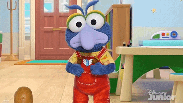 a cartoon character from disney junior is holding a book