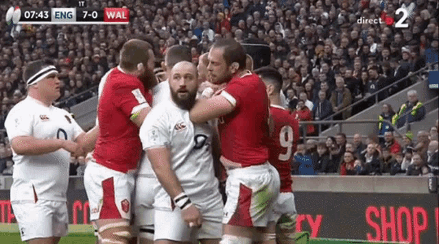 a group of rugby players on a field with the numbers 7 and 9 on their jerseys