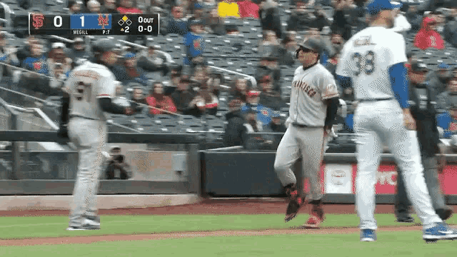 a baseball player in a san francisco giants uniform stands on the field talking to another player .
