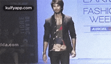 a man walks down the runway at a fashion week