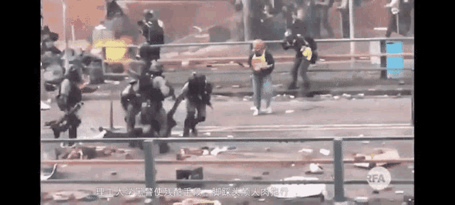 a group of police officers are surrounding a woman holding a baby in a video taken by rfa