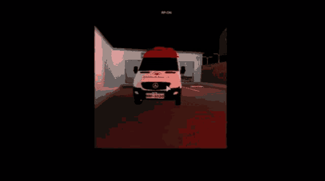 an ambulance is parked in front of a building with a license plate that starts with the letter s