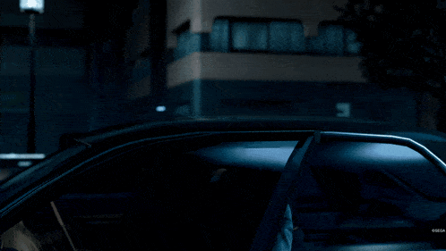 a man in a black suit has a large eye patch on his eye