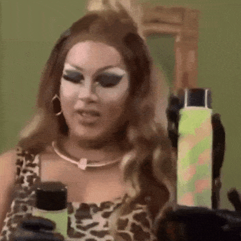 a woman in a leopard print top is holding a bottle of lotion