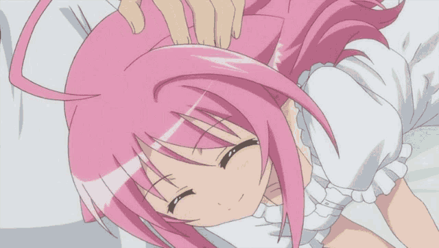 a girl with pink hair and a white shirt is laying down