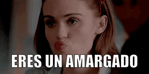 a woman is making a funny face with her mouth open and the words eres un amargado are written above her .