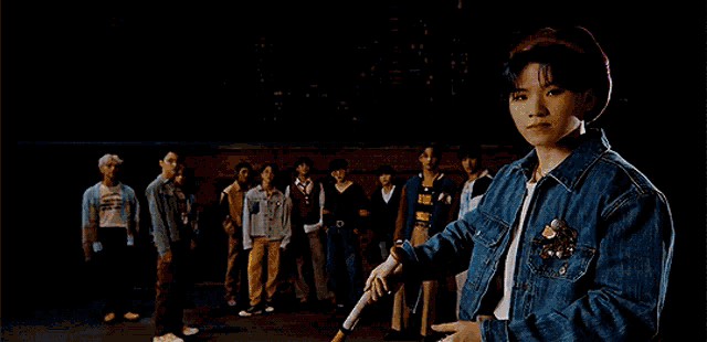 a man in a purple hat is holding a baseball bat in front of a window .