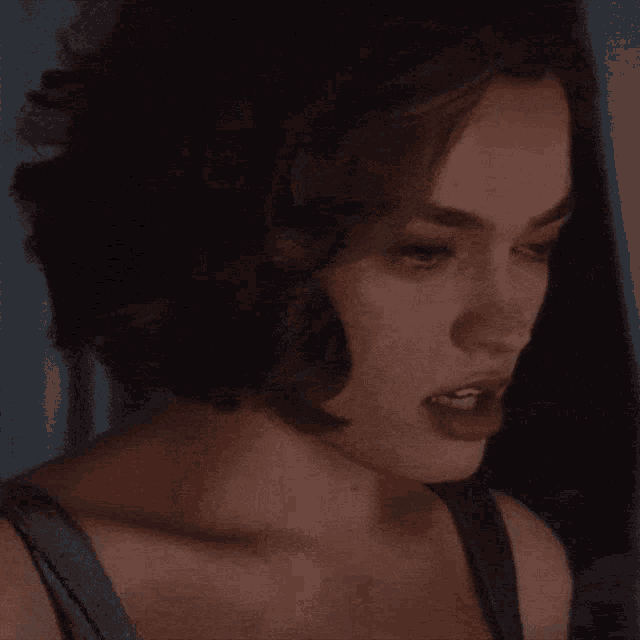 a close up of a woman 's face with her eyes closed and her mouth open .