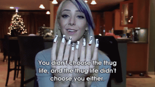 a woman with purple hair and white nails says you didn 't choose the thug life