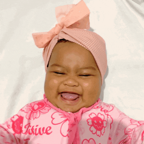 a baby wearing a pink outfit that says " i 'm a kiwie "