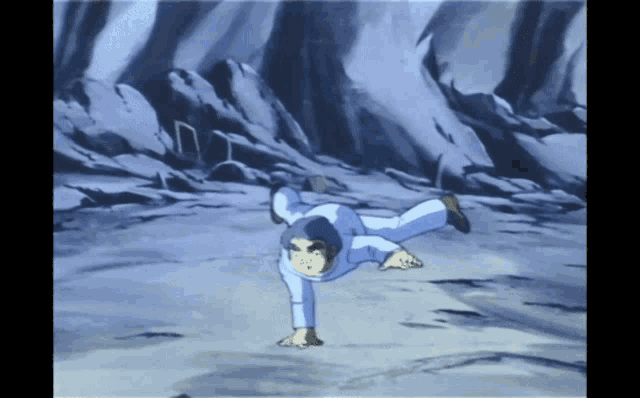 a man in a white shirt is doing a handstand on the ground