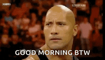 a bald man is standing in front of a crowd and saying `` good morning btw '' .