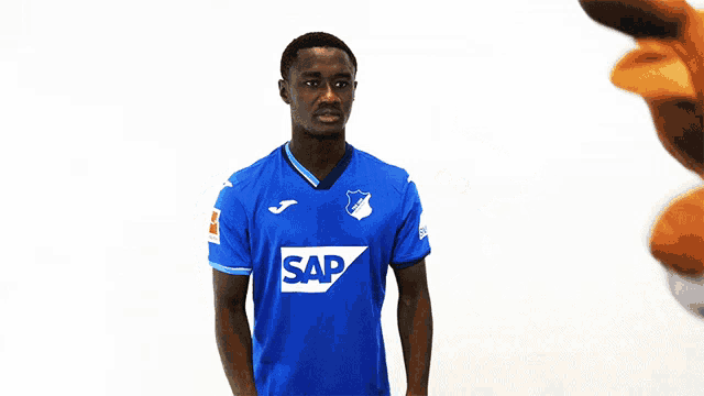 a man wearing a blue shirt that says sap