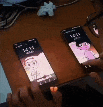a person is holding a cell phone that says 14:11 on it