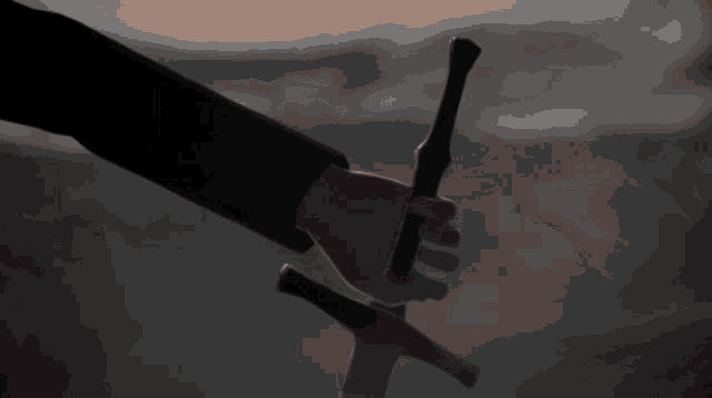 a person is holding a sword with a fire coming out of it