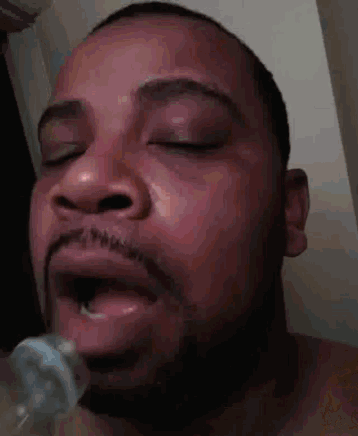 a close up of a man 's face with his eyes closed